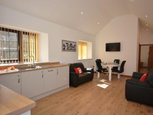 a kitchen and living room with a couch and a table at 2 bed property in Bath 72837 in Chew Magna