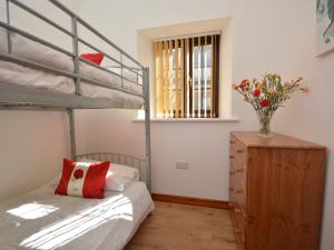 a bedroom with a bunk bed and a wooden dresser at 2 bed property in Bath 72837 in Chew Magna