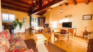 a living room with a couch and a table at Villa au calme à proximité de la mer in La Couarde-sur-Mer