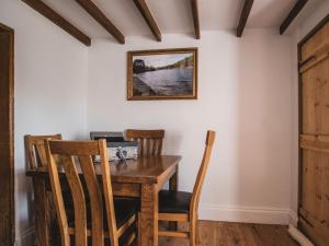 a dining room with a wooden table and chairs at 2 Bed in Osmotherley 77528 in Osmotherley
