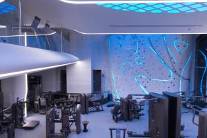 a gym with a climbing wall and weights at Tsarsky Hotel in Kyiv