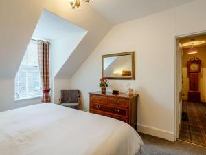 a bedroom with a bed and a mirror and a dresser at 2 bed in Inverness CA328 in Inverness