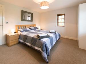 a bedroom with a large bed and a mirror at 3 bed in York HH015 in Tockwith
