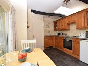 a kitchen with a table with a bowl of fruit on it at 1 Bed in Wolsingham 36674 in Wolsingham