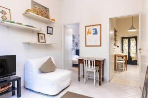 a living room with a white couch and a table at Santa Croce Comfort Apartment in Florence