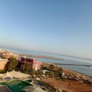 a view of a beach with a resort and the ocean at Comfort Zone at Turtles Beach Resort in Hurghada