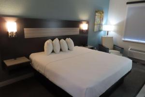 a bedroom with a large white bed with two pillows at Best Western Prime Inn & Suites in Poteau