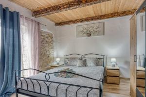 a bedroom with a bed and a wooden ceiling at Holiday House Orbanic in Modrušani +25 photos