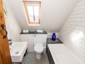 a white bathroom with a toilet and a sink at The Old Stables in Chipping Campden +27 photos