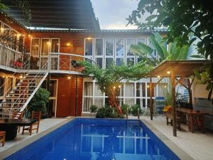 a house with a swimming pool in front of a building at A La Mer home Vũng Tàu in Vung Tau