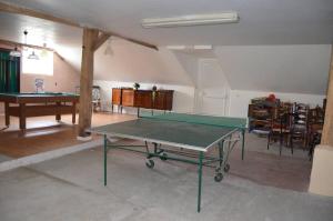 a living room with a ping pong table in it at Gite Penn ar bed in Cast