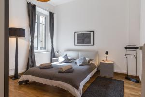 een slaapkamer met een bed met 2 kussens erop bij Appartement Luxueux Centre Ville in Colmar