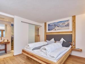 a bedroom with a large bed with white pillows at Haus Laterndl in Längenfeld