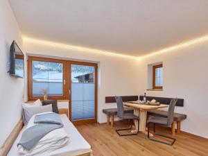 a bedroom with a bed and a table and chairs at Haus Laterndl in Längenfeld