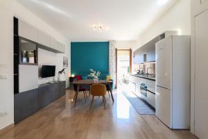 a kitchen with a table and a blue wall at PrimoPiano - Novara in Milan
