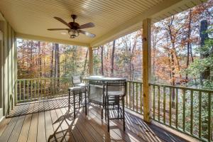 a screened porch with a ceiling fan and two stools at Waterfront Lake Anna Home Kayaks and Private Dock in Mineral