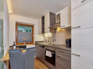 a kitchen with a sink and a stove top oven at Haus Laterndl in Längenfeld +20 photos