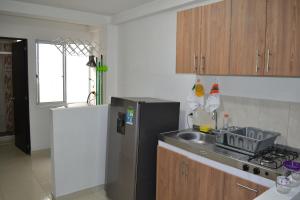 a kitchen with a stainless steel refrigerator and a sink at GURUS FR | NUEVO apto especial para familia in Pereira