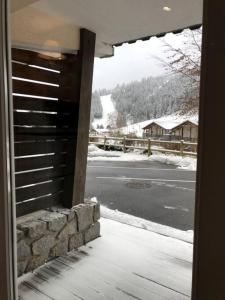 a view from the door of a house with a snowy street at Aux pieds des pistes 4/6 personnes in Gérardmer
