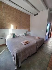 a bedroom with a large bed with two towels on it at Cortijo El Paraíso in Los Escullos