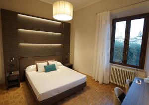 Postel nebo postele na pokoji v ubytování Hotel Continentale