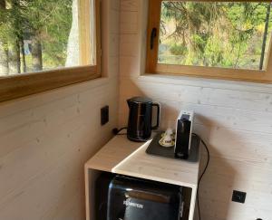 a coffee maker on a table in a tiny house at Camping Železná Ruda in Železná Ruda