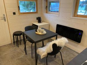 a dining room with a table and chairs and a coffee maker at Camping Železná Ruda in Železná Ruda