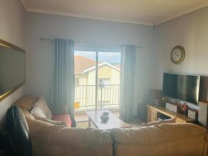 a living room with a couch and a tv at The Beacon Unit 32 in East London