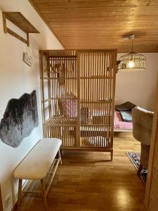 a room with a wooden cage with a bench and a bed at Höri-glück in Öhningen