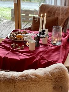a table with a red table cloth with candles and food at Höri-glück in Öhningen