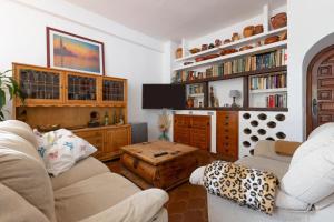 a living room with two couches and a tv at Almarchada 38 in Mijas