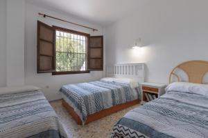 a bedroom with two beds and a window at Almarchada 38 in Mijas +26 photos