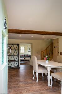 a dining room with a table and chairs at Brook Cottage in Kelling