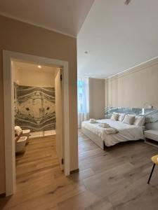 a bedroom with a bed and a painting on the wall at Breccia Nel Mare in Carrara