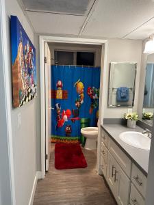 a bathroom with a super mario shower with a red rug at Hollywood Apartment One Bedroom with Mario in Los Angeles