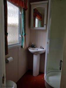 a bathroom with a sink and a shower at Green Shores in Weybourne