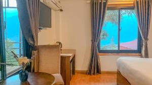 Postel nebo postele na pokoji v ubytování Tiger Sapa hotel