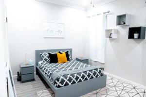- une chambre avec un lit doté d'oreillers jaunes et noirs dans l'établissement EXCLUSIVE Modern Apartment in Nasáu, Bahamas, à Nassau