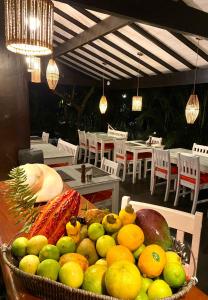 a basket of fruit on a table in a restaurant at Mangueira Boutique Hotel Moreré in Moreré +50 photos