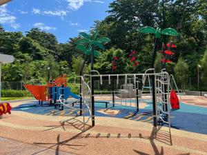 a playground in a park with at Mutiara Melaka Beach Resort by TZWan in Tangga Batu