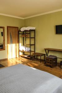 a bedroom with a bed and a shelf with a mattress at Sadyba DarKa in Ternopil