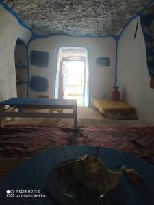 a room with a room with a bed and a window at Cave's on to the beach in Douaïra