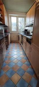 a kitchen with a tiled floor and a window at Komfortables und sauberes Zimmer in Leipzig