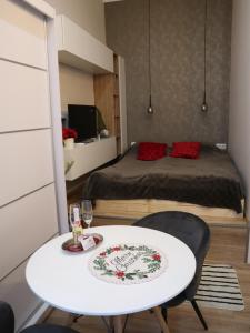 a bedroom with a bed and a white table and chair at Glamour mini home in Esztergom