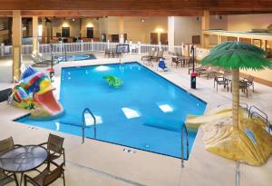 a large swimming pool with a slide and a water park at Ramkota Hotel - Casper in Casper