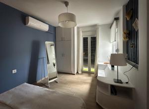 a blue room with a bed and a lamp at Villa Yolanda 3 - Apartment Leda - Luxury family apartment, sea view in Poros