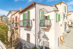 a row of houses with balconies and a street at Appartamento La Scaletta in Capoliveri