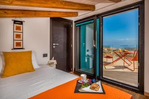 a bedroom with a bed and a table with a tray of food at Villa Pharus Scopello in Scopello +83 photos