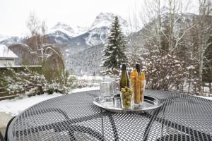 a table with two bottles of wine and glasses on it at Feriensiedlung Trü 9 in Scuol