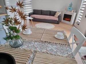 a living room with a table and a couch at La Casuță in Dej
